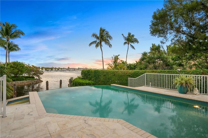 Welcome to Florida living at its finest! From the moment you enter the foyer of this Coastal Style home, you are greeted by one of the best, unobstructed views of the Crayton Cove & Naples Bay. A true “wow” factor that never gets old. The interior of this home is stunning with soaring ceilings, granite tile & hardwood floors, new lighting and interior/exterior paint in 12/20. The home boasts nearly 7,700 total sq ft of living space & includes 4 bedrooms plus an office, 4 full & 2 half baths, a large media room, and a private elevator. Open up the full corner hurricane impact sliders from the great room and enjoy true indoor/outdoor living. Relax on the first-floor infinity pool deck & watch the boats come and go from the Naples Yacht club OR hop on your own boat housed right on property, under cover, on your 13,000 lb boat slip with an additional 50’ yacht dock. Direct access to The Gulf of Mexico make this home a boater’s dream. Imagine finishing your day on the 2nd level terrace where you can enjoy one of Naples’ famous sunsets to the west down the canal. This one of a kind home, perfect for entertaining, is waiting for you to come live your best life!
