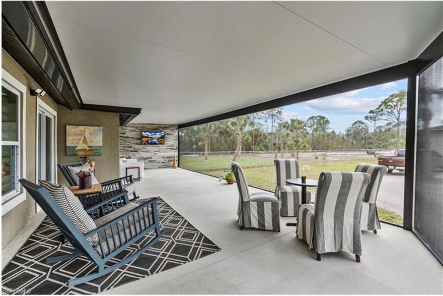 Welcome to your own private retreat in the heart of Golden Gate Estates! This meticulously maintained 3-bedroom, 2-bath home sits on over an acre of fully cleared, fenced, and gated land—ideal for a young family, hobbyist, or empty nesters seeking a peaceful slice of paradise. There’s plenty of room for horses, and to add a large pool to complete the perfect setting for Florida outdoor living. Enjoy balmy nights al fresco on the Amazing extended lanai w/outdoor kitchen & TV area. Long circular driveway w/separate parking pad for guests! 

Inside, the home features brand-new luxury vinyl plank flooring throughout (with a lifetime warranty) and fresh paint inside and out, creating a light and airy atmosphere. The thoughtfully appointed kitchen is perfect for entertaining, with granite countertops, stainless steel appliances, and a wraparound island. Both bathrooms are stylishly updated with quartz countertops and floor-to-ceiling tile.

The primary suite offers a luxurious escape with an oversized walk-through closet featuring custom cedar shelving and a built-in vanity. The en-suite bath includes split vanities and an oversized tiled shower.  

A standout feature is the detached 30x30 non-conforming garage, which has been thoughtfully upgraded with electric and plumbing. This versatile space currently serves as a spacious art studio, hobby room, and office, and could easily function as private guest quarters with its own separate entrance. Plans are available to convert it fully into a guest house. There’s also a separate tool shed or “she shed” for extra storage or creative space.

The home also includes a newer roof (2018), a tankless water heater, and a one-year home warranty to be provided at closing. Located in a desirable area with excellent schools nearby, this property is just minutes from I-75, convenient shopping, and the exciting new Big Cypress Regional Park.

Enjoy the best of country living with modern comforts and endless potential in this move-in-ready Golden Gate Estates gem!