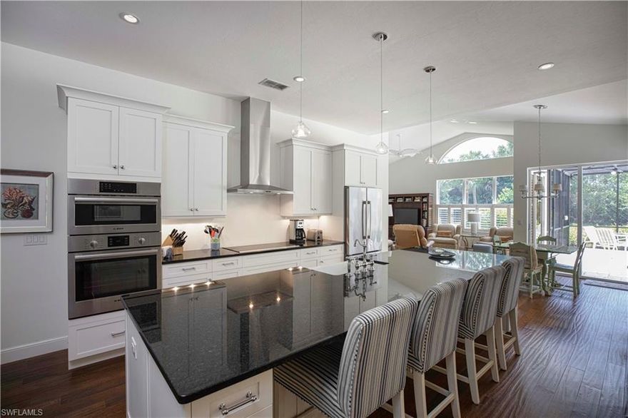 Come see this beautifully recently renovated home on one of the premium lots in Pelican Landing! This 4 bedroom, 3 full bath home boasts over 3,000 square feet of living space under air, with open concept that flows out to over 5,000 sf of space total. Recent gut renovation appointed this home with luxury finishes throughout. The kitchen boasts new white shaker custom cabinetry, soft close drawers, premium fixtures, Bosch appliances and custom hood and lighting – all aligning beauty and function. New, rich color and texture carved wood flooring throughout. Doors replaced with solid core. Plantation shutters throughout. The entire home was upgraded with storm protection on all windows and doors. New wine fridge added to wet bar. Bathrooms updated with new walk in tile showers, frameless glass, new vanities are more. New roof in 2018. New landscaping 2019. Large lanai deck is travertine tile with a free form pool and spa. Brand new white pearl pool finish in spring of 2019. New New New Pelican Landing offers a Private Beach, Tennis, Canoe and Kayaks, Fitness Facilities and great location. Boat takes residents to private beach. Avoid the hassle of a reno - see this today!