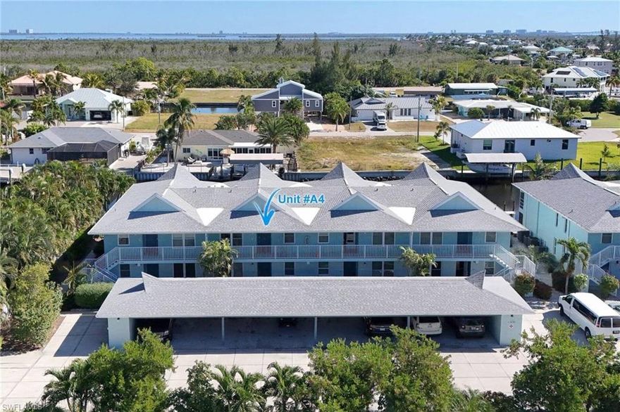 Welcome to the completely renovated Fisherman's wharf condo complex. Upgrades include new roof on the complex including the covered parking area--all new paint--updated electric & plumbing--new hand rails--all new landscaping. This is a second floor unit with 2bd & 2ba. All new flooring in the great room & bedrooms. Recent window replacement including the sliders to the screened porch. Beautiful second floor view overlooking the boat docks. This is a true boaters dream location with your boat right where you can see it when you are here & when you leave it is secured in the complex boat storage yard. No bridges to the gulf & outer islands. There is a heated pool & shuffleboard court. All of this is located within walking distance to the local restaurants--marina & entertainment. Don't forget to check out the virtual tour?????????