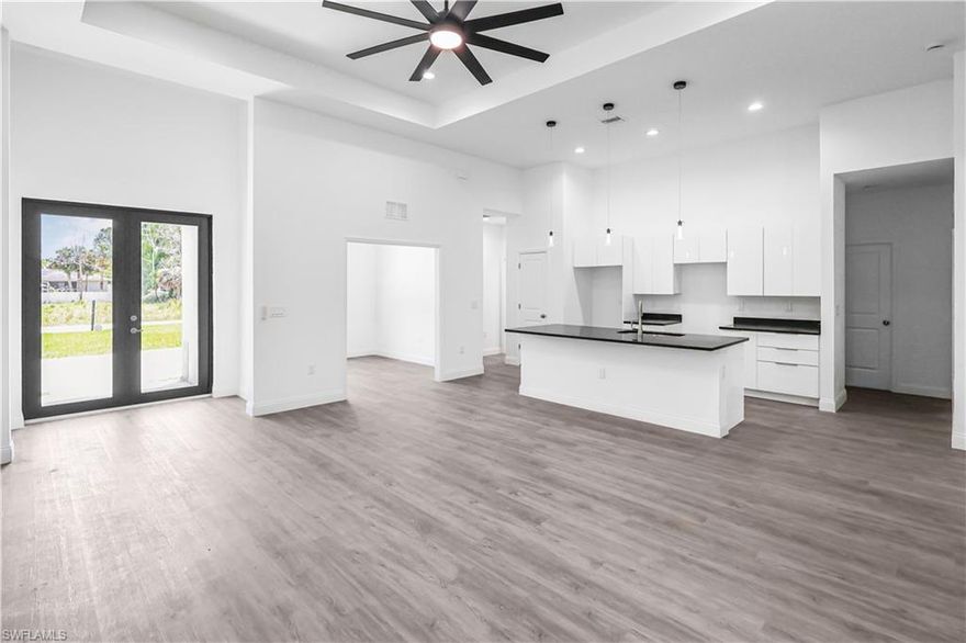 Experience the Florida Lifestyle in this meticulously designed, modern, move-in-ready home! This home boasts 3 bedrooms, a den, 2 bathrooms, an open floor plan, 12 ft. ceilings, an oversized side-entry double car garage, impact windows, a lanai, sprinkler system, and an extended concrete driveway. The open floor plan seamlessly combines a spacious living area, a deluxe kitchen island, and a separate dining room, making it an ideal space for entertaining. The master bedroom features two spacious walk-in closets, while the bathroom includes dual vanities and a walk-in shower. You'll find stainless steel appliances, granite countertops, soft-close shaker cabinets, luxury vinyl flooring, and energy-efficient LED lighting throughout the home. Conveniently situated near SWFL International Airport, FGCU, shopping centers, and Top Golf, this property offers effortless access to the best of Southwest Florida.