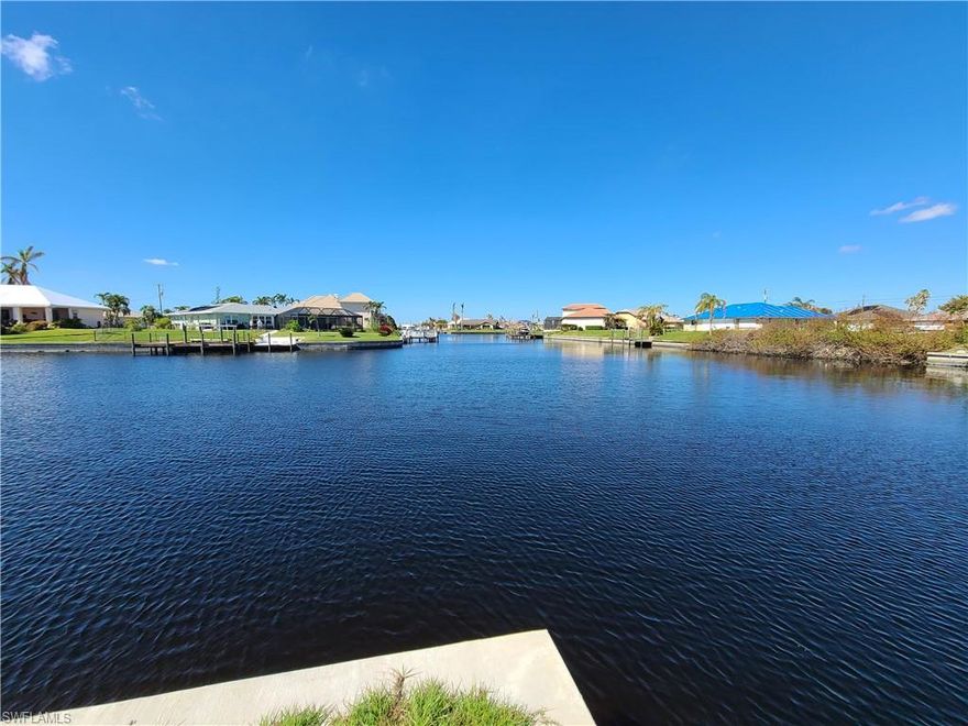*** Rarely available! *** Huge oversized 0.443 acre corner lot with approx. 210' water frontage on 170' & 135' wide intersecting canals with boat access to the Gulf of Mexico. Enjoy breathtaking sunsets & long water views! A new concrete seawall was installed in May 2020, so no delays on your plans to build. All city utilities are available at this property! Quiet location in desirable SW Cape Coral, an area of many new construction homes. Build your dream home within 12 to 14 month after permit approval & create instant equity. Plans for a luxurious & modern new construction home with 2,844 sq.ft. living area are in place, featuring 4 bedrooms, 3.5 bathrooms, a gourmet kitchen with high end Bosch stainless steel appliances, an oversized kitchen island with waterfall quartz counter tops & a walk-in hidden pantry, a large greatroom with 23' wide pocketing sliding glass doors & a 3-car garage with epoxy flooring. Enjoy Florida outdoor living! The 45' x 14' covered lanai with an outdoor kitchen & a pine ceiling offers plenty of room for all your patio furniture. Savor your favorite drink in a sparkling pool with a 360 overflowing spa, 3 built-in bar stools & sparkling glass tiles.
