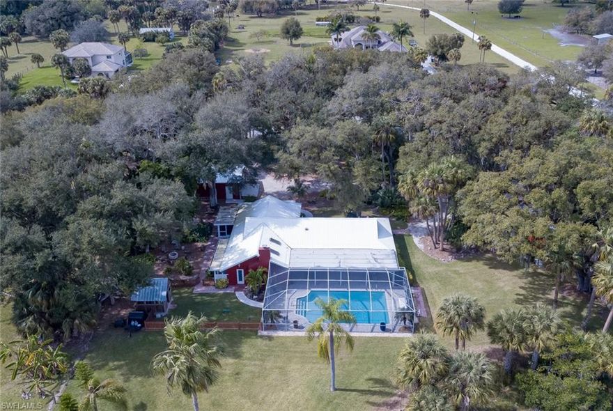 WELCOME TO BUCKINGHAM!  EXPERIENCE SW FLORIDA COUNTRY LIVING AT ITS ABSOLUTE BEST!  THIS EXQUISITE COUNTRY SETTING IS SITUATED ON 2.5 ACRES OF LUSH LANDSCAPING WITH A FULLY STOCKED POND! THIS STUNNING, FULLY RENOVATED AND UPDATED (2015) HOME FEATURES (4) BEDROOMS, (3) BATHS WITH A SALTWATER POOL!  APPROXIMATELY 2700 SQ. FT OF LIVING AREA!  WOOD-LIKE TILE FLOORING THROUGHOUT!  CROWN MOLDING!  CUSTOM PAINT!  6-INCH BASEBOARDS! CUSTOM DESIGNED KITCHEN WITH GRANITE COUNTER TOPS AND WOOD CABINETRY WITH POT FILLER, UNDER COUNTER MICROWAVE DRAWERS AND PULL-OUT SHELVING!  WOOD BURNING FIREPLACE IN FAMILY ROOM. (2) MASTER EN SUITES WITH CUSTOMIZED SHELVING IN WALK-IN CLOSETS!  SPACIOUS LANAI!  SALTWATER POOL!  GUEST OR MOTHER-IN-QUARTERS (FULLY REMODELED) FEATURES A SPACIOUS BEDROOM AND BATH, FULL KITCHEN WITH LOADS OF STORAGE AND A SCREENED LANAI OVERLOOKING THE LIGHTED, OUTDOOR FIREPIT!  PLANTATION SHUTTERS THROUGHOUT. FENCED AREA FOR KIDS/PETS!  DETACHED OUTDOOR SMOKEHOUSE~PERFECT FOR GRILLING AND ENTERTAINING!  GRAVEL, CIRCULAR DRIVEWAY!  OVERSIZED, DETACHED (2) CAR GARAGE!  DETACHED RV STORAGE BUILDING! SHORT WALK TO BUCKINGHAM FARMS.  THIS TRULY IS A MUST SEE!