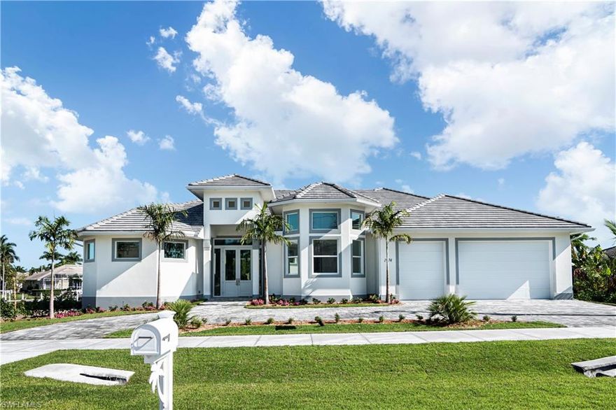 Stunning and brand-new! MOVE-IN-READY 3,200 sq ft luxury "coastal-contemporary" residence -- all on one level. Spacious 5 bedrooms, 3.5 bathrooms, oversized 3-car garage with 10-foot overhead doors and a huge circular driveway. Saltwater pool, cascading spa & sun shelf with color LED lights. Direct access with 100' of new seawall -- with no rear neighbors for perfect privacy -- and just seconds to open water. This 'Coastal' floor plan by JP Homes includes ultra-custom features, high-end finishes and upgrades. Stone flooring, 10-foot impact entry doors & 90-degree sliders, soaring 12-16 ft ceilings with crown detailing & coffers, tricked-out LED lighting, dual ACs, smart home tech, frameless cabinetry with quartz tops, JennAir appliances. TWO master suites, and SO MUCH MORE! This home sets the bar for luxurious coastal living with an extensive warranty included. This is a single-story residence, built more than a full foot above required flood code, yet has NO steps! Come take your own private tour.