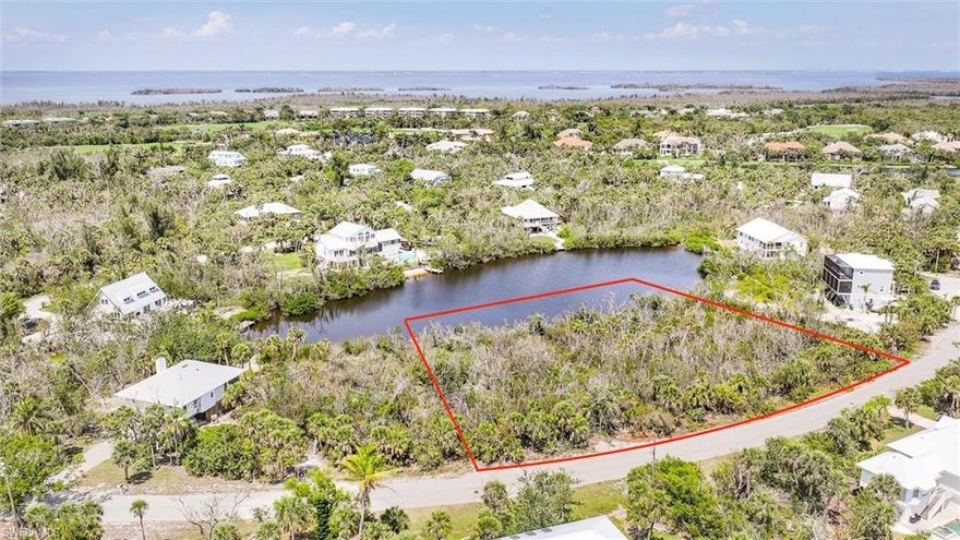 Discover an extraordinary opportunity to create your island sanctuary on Sanibel's enchanting Blue Crab Court. This exceptional lakefront property presents a rare opportunity to craft your dream retreat in one of the island's most coveted and secluded neighborhoods, nestled within the tranquil embrace of Dinkins Bayou. Boasting an impressive 193 feet of pristine lake frontage, this remarkable parcel offers an unparalleled canvas for designing your perfect island home. The property's picturesque setting comes alive with native wildlife, creating a living tapestry of natural beauty that changes with each season. Imagine waking to the gentle sounds of nature while enjoying panoramic water views that stretch across the peaceful lake. The strategic location provides effortless access to both gulf and bay waters via the nearby Henderson Road boat ramp, positioning you perfectly for aquatic adventures. Your future home will be ideally situated for exploring Sanibel's legendary attractions, including the world-renowned Ding Darling National Wildlife Refuge, where countless species of birds and marine life thrive in their protected habitat. This distinguished property places you within comfortable reach of Bowman's Beach and Blind Pass Beach, offering endless opportunities for shelling, swimming, kayaking, paddle boarding and sunset watching. The vibrant community amenities are easily accessible, including educational resources at The Sanibel School, cultural opportunities at B.I.G. ARTS and recreational and fitness facilities that enhance island living. The zoned designation allows for thoughtful development that harmonizes with the island's natural character while providing flexibility for your architectural vision. Whether envisioning a contemporary or classic island home, this exceptional lot provides the foundation for creating spaces that seamlessly blend indoor and outdoor living. This represents one of Sanibel's finest values for discerning buyers seeking a premium building site in an exclusive setting that captures the essence of sophisticated yet casual island living.