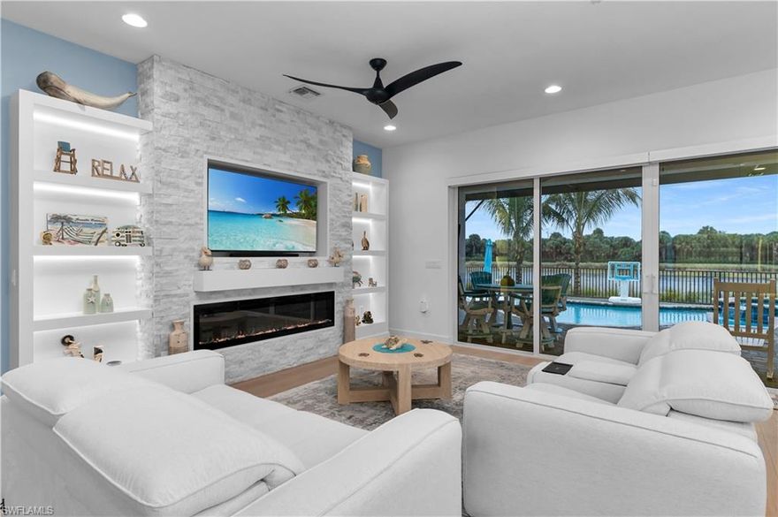 Welcome to this upgraded Pelican model, a residence that redefines luxury living with sophistication. Every detail has been meticulously selected to create a seamless blend of elegance. The experience begins the moment you enter through the 14-foot foyer, where the soaring ceiling height and expansive sight lines immediately set a tone. Step into the heart of the home, an impressive chef’s kitchen crafted for both culinary inspiration and effortless entertaining. Here, sleek quartz countertops extend into a fully integrated matching backsplash, creating a clean, cohesive aesthetic. Premium stainless-steel appliances—including a natural-gas range while soft-close cabinetry with refined molding and hidden pull-out features exemplify thoughtful design. Soft ambient lighting from pendants and recessed LEDs casts a warm, inviting glow. As the main living area flows gracefully toward the outdoors, sliding impact glass doors draws your eye to the home’s private outdoor oasis. Step outside to find a heated gas pool and spa, enveloped by a panoramic no-see-um screen enclosure that allows uninterrupted views of the lake and protected preserve. With coveted southern exposure, the outdoor living space is bathed in natural light throughout the day. Inside, the elevated upgrades continue with premium flooring that flows harmoniously throughout, enhancing the home’s sophisticated appeal. Impact-resistant windows and doors, and a whole-house water filter, offer peace of mind and energy efficiency. The den, enhanced with custom-built cabinetry, provides a stylish and functional space for a home office. The primary suite is a sanctuary of comfort and design excellence. A custom-crafted wood feature wall adds depth and character, creating a serene backdrop for rest and relaxation. The spa-inspired primary bathroom is impeccably upgraded with elevated cabinetry, designer mirrors, custom lighting, and beautifully finished shiplap walls—evoking a boutique-hotel feel. Custom closets provide exceptional storage, ensuring everything has a place and maintaining the home’s clean, uncluttered presentation. Beyond the home itself, Valencia Trails elevates the lifestyle even further with active, social, and wellness-focused living. The impressive 43,000-square-foot clubhouse serves as the centerpiece of the community, offering a full-service restaurant and bar, a state-of-the-art fitness facility, a luxurious salon and spa, card and game rooms, art studios, and a fully appointed demonstration kitchen. Outdoors, residents enjoy a resort-style pool, lap and resistance pools, six tennis courts, eight pickleball courts, and miles of beautifully landscaped walking and biking trails. Even four-legged residents are thoughtfully accommodated with two private dog parks. Opportunities to own a home of this caliber—combining privacy, premium upgrades, and an outstanding location, within one of Naples’ most vibrant and prestigious 55+ communities.