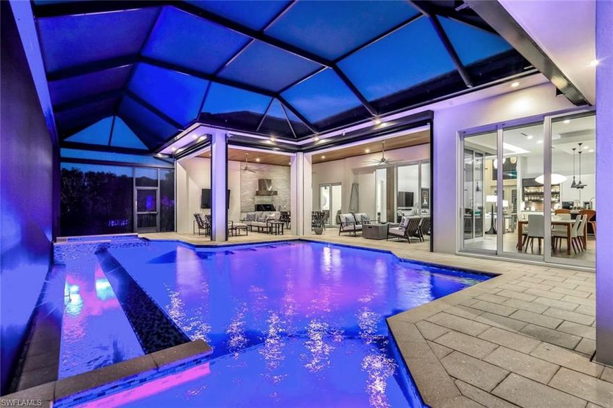 Welcome to a masterfully engineered waterfront estate where European sophistication meets Florida’s premier boating lifestyle. Offered furnished, this exceptional residence showcases uncompromising craftsmanship, intelligent design, and state-of-the-art automation throughout. From the moment you arrive, the new roof, fresh exterior paint, and pristine new cage set the tone for a home that has been meticulously curated and impeccably maintained. Inside, the home unfolds into a refined modern interior featuring all linear air vents, LED lighting throughout, plantation shutters, custom wooden closet shelving, and fully automated electric roll-down shades and shutters. Imported custom glass cabinetry from Germany anchors the home’s sleek aesthetic, paired seamlessly with a top-tier Miele appliance suite, including a built-in coffee system, refrigerator, range, cooktop, steam oven and wall oven, dishwasher, and stainless steel sink liner—delivering a chef’s kitchen that is both elegant and functional. The primary suite is a serene retreat with dual vanities and spa-inspired finishes, while guest accommodations include a Jack-and-Jill pool bath, additional guest bath, and full ADA-compliant accessibility, complemented by advanced foam insulation for superior energy efficiency and sound control. Designed for effortless living, the home features a 5-ton zoned air conditioning system (26 SEER) with four zones, a Stiebel Eltron tankless water heater, solar panels, and low-voltage lighting, ensuring comfort and sustainability year-round. The laundry room includes an Electrolux washer and dryer, utility tub, and custom cabinetry, while the epoxy-finished three-car garage with a separate one-bay space offers an EV charging station. Outdoors, the home transforms into a private resort. A tongue-and-groove lanai ceiling frames an entertainer’s dream with an alfresco grill and Perlick refrigerator, seamlessly connected by dramatic 90-degree sliding glass doors. The heated infinity-edge pool, complete with sun shelf and integrated spa, is heated by both electric and solar systems with smart automation. Boating enthusiasts will appreciate minutes to open water, a 10,000-lb boat lift with canopy and remote, kayak launch with ladder, water at the dock, and raised electrical dock boxes. The spring-fed canals are home to manatees, dolphins, and stingrays, offering a rare waterfront experience. Just around the corner, enjoy tranquil walks and wildlife views at Sirenia Vista Park, while a short drive leads to fine dining, entertainment, and the highly anticipated Seven Islands Project. Every detail—from TOTO toilets to the fully automated smart-home system—reflects a commitment to luxury, performance, and lifestyle. Schedule your private showing today and experience elevated Cape Coral waterfront living.