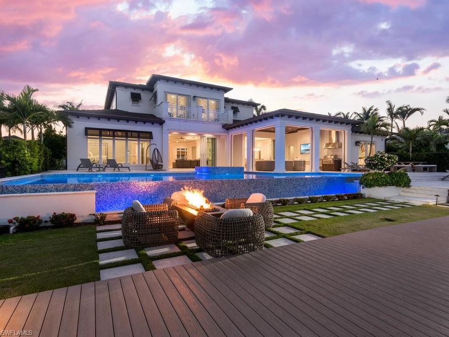 Sensational British West Indies inspired estate with resort level outdoor living to deliver the ultimate Aqualane Shores waterfront retreat. Greeted by an expansive motor court framed by an enchanting landscape design by ALD, the owners will enjoy an open layout with soaring ceilings that gracefully lead to the unbelievable outdoor entertainment and waterfront vistas beyond. Featuring a rare combination of 6 bedrooms and 6 and a half bathrooms, the custom Legno Bastone hardwood floors are perfectly accented by natural stone finishes and soft blue and green hues to communicate luxury and relaxation. The chef's kitchen has both a prep and serving island with Wolf and Sub Zero appliances. First floor master wing with separate his and her closets and great views over Heron Cove. One of a kind 53' infinity edge pool and spa with 84' custom Azek dock with boat lift and fire pit are unmatched. Two more first floor bedrooms with three bedrooms upstairs and lounge are perfect for larger parties. Whole home generator, elevator, Ruffino cabinetry and Elan A/V system complete this masterpiece. Truly one of Aqualane Shore's best homes is also steps to the beach and historic 3rd St South.