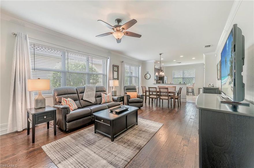 H.16288 - This first generation Pine Spring home has lots of custom touches, wood flooring in the third bedroom/den, living area, and hallway, updated shower with tile to the ceiling. Tall baseboards and a cased opening at the foyer. Fully storm protected with accordion shutters on all openings. A wall of windows on the south side of this home keep it bright all day.Updated ceiling fans and light fixtures and the dark cabinets add to the rich feel of this home. The kitchen can accommodate a small table for two use the dining area when you have more people dining with you   The pantry is wide, giving you a look at everything inside without digging. The screened patio lets you enjoy the outdoors from the shade of your lanai, or in the sun of your patio. Villagewalk is a community with 22 miles of walkways and pedestrian bridges with lots of lakes. All walkways take you to the Town Center Amenity area where there are non-stop activities, either planned, or spontaneous. Spa, restaurant/bar, bagel ship, post office, hair salon and gas station are just some of the amenities. Expanded cable programming and high speed internet are included in the already low HOA fees.