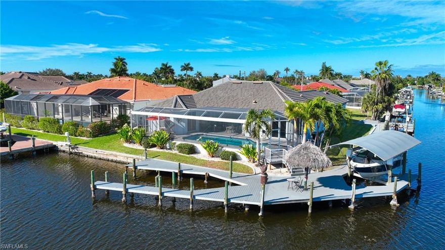 Premier Luxury Waterfront Estate | 235’ Frontage | Unique Corner Lot | River Access
Experience exceptional luxury waterfront living with approximately 235 feet of water frontage on wide intersecting canals, just minutes to the river with sailboat access and no bridges. Ideal for the true boating enthusiast, the property features two boat lifts, a jet ski lift, and a rare wraparound dock accommodating multiple vessels, including yachts up to 50 feet.
The home offers impressive curb appeal with a grand entry, four-car garage, and elegant paver driveway. Fully renovated in 2021, it showcases a new designer kitchen, upgraded flooring throughout, custom pavers, and a beautifully updated pool deck. Lush tropical landscaping and mature coconut palms create a private, resort-style setting. A rare opportunity to own a premier deep-water estate in the highly desirable Yacht Club area.