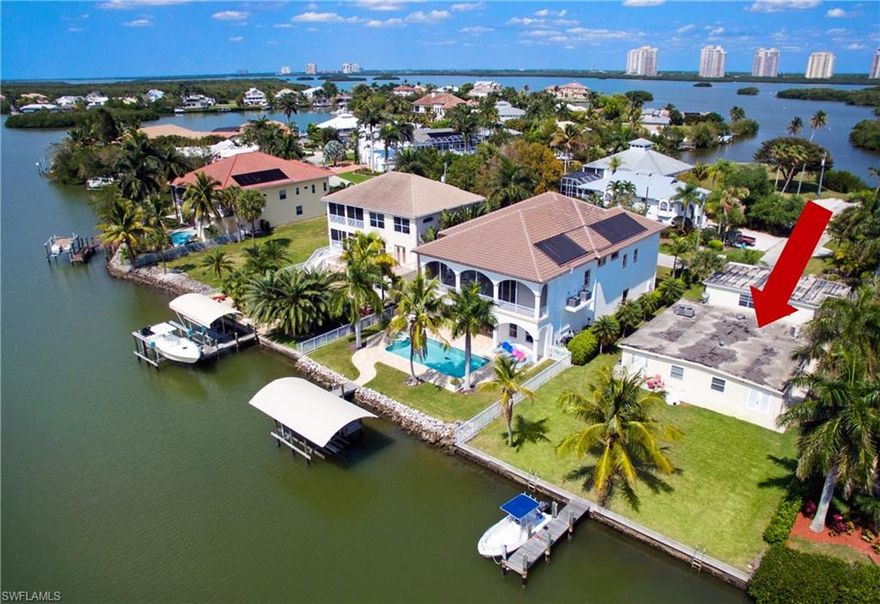 Fantastic investment opportunity in the highly-coveted Carolands on Bonita Beach: a peaceful neighborhood with multi-million dollar homes surrounded by water ways with direct access to the Gulf of Mexico. Delight in Western exposure with sunset bay views, a 5 minute walk to the beach, fishing from your private dock, and a short boat ride to the Gulf. This home offers optional rental income potential (currently brings in about $2,700 per month) until you build your perfectly-located dream home. Largest side of duplex is 4 bedrooms and 2 bathrooms. Smaller side is 1 bedroom and 1 bathroom. ***Please view the virtual tour URL to view a walk through of the home and flyover of the Bayfront setting***