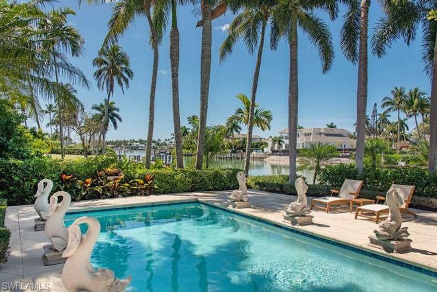 H.15759 - Price Reduced! Classic, tropical, charming! On a lot and a half, 159 feet of water-frontage on Runaway Bay. Boat dock w/direct Gulf access! Eclectic, beachy, inviting and happy 4,951 LA. Updated  casual elegance. Vaulted ceilings, plenty of natural light! New roof in 2020 tops this meticulously maintained home. Large kitchen w/huge island, custom cabinets, marble subway tile backsplash/top appliances. Two family rooms for large gatherings, pretty breakfast room, beverage bar/expansive living room w/fireplace/built-ins. Ideal for entertaining indoors & out. Florida room w/tongue & groove vaulted ceiling, view of pool, playful fountains, sun deck, bay! Spacious master suite w/high ceilings, morning bar & sitting area w/view of Runaway Bay & pool. Master bath is a grand retreat w/dual vanities, king-sized shower & soaking tub. Eligible for Port Royal Club membership to enjoy the finest private club experience w/world-class dining, pristine beach w/club services, beachside pool, fitness, tennis & spa facilities. A must see!