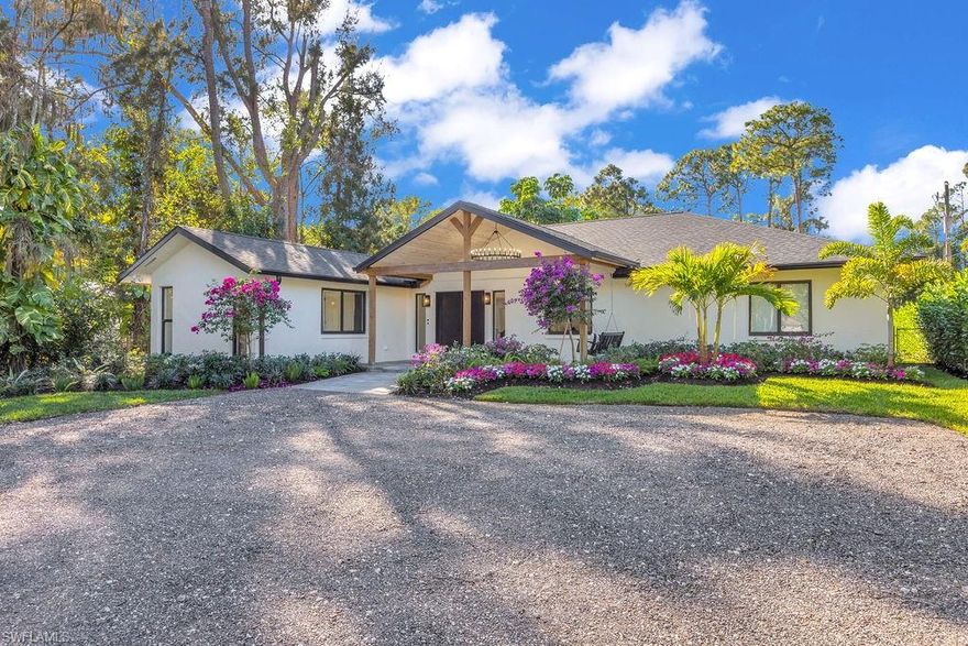 Your private resort awaits! A true pickleball lover’s dream private court. This exceptional estate west of 75 sits on just over an acre, never flooded, offering unmatched privacy with NO HOA, all just minutes from downtown Naples. Properties that blend this level of private amenities, lifestyle, and location rarely come available. A grand vaulted entry sets the tone as you arrive, featuring a statement chandelier and charming porch swing patio. Step inside to find a fully renovated, turnkey-furnished residence offering 4 bedrooms and 3 bathrooms, finished with luxury vinyl flooring throughout. The expansive great room showcases vaulted ceilings and custom tile accents, seamlessly flowing into the oversized kitchen, dining area, and extended wine bar—perfect for entertaining. The chef’s kitchen is thoughtfully designed with all-new cabinetry and appliances, complemented by a Kinetico full reverse-osmosis system. Additional upgrades include impact windows and doors, full irrigation system, and brand-new professional landscaping. Each bathroom has been beautifully tiled with spa finishes. From the main living area, large sliding glass doors draw you outdoors to a true backyard oasis. The expansive deck features an outdoor kitchen, pizza oven, and generous entertaining space. The new saltwater, heated pool is paired with a fire-pit seating area, creating an inviting retreat for both daytime enjoyment and evening relaxation. Completing the ultimate Florida lifestyle is a full-size pickleball court lining the back of the property. A long private driveway leads to a brand-new, epoxy-finished 3-bay garage with workshop space, ideal for storing boats, vehicles, and recreational toys. Investors welcome. This property is already producing strong Airbnb rental income, making it a rare opportunity for both luxury living and exceptional investment potential. 3155 64th St SW, truly has everything you could want and more in a place to call home. Schedule your showing today!