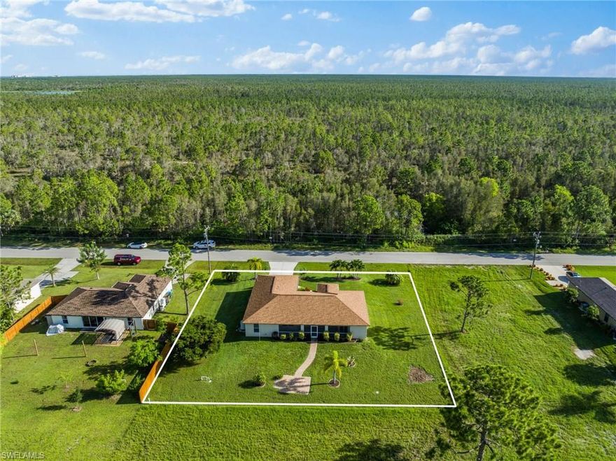 *** SPACE BTWN YOU and NEIGHBORS! THIS HOME IS CLEAN WITH A GREAT 3 LOT SITE AND A BEAUTIFUL, PEACEFUL, RELAXING LOCATION*** Preserve across the street and 10 acres behind zoned for future City Park. NO FLOOD INSURANCE REQUIRED (Zone X). As you walk inside, you'll notice how well this home flows with a bright & airy floor plan that includes an open kitchen and split bedroom design. This home feels much larger than it is. Its gorgeous interior includes a triple panel, 8-ft slider that glides smoothly and pockets completely out of the way. The lanai is HUGE and overlooks 10 acres of city owned land designated for a future park. More green space in front because of a designated preserve across the street. Roof 2021. AC 2021. Well Pump 2024. Water Softener 2024. Other recent updates include new interior and exterior paint, granite kitchen and baths, beautiful tile floors, stainless appliances, and back yard paver patio. This home has been owned and loved by meticulous owners. Utilities YEARS out scheduled for 2040 at earliest per City.  Ready to Move In! Come Enjoy the Relaxing BEAUTIFUL VIEW!