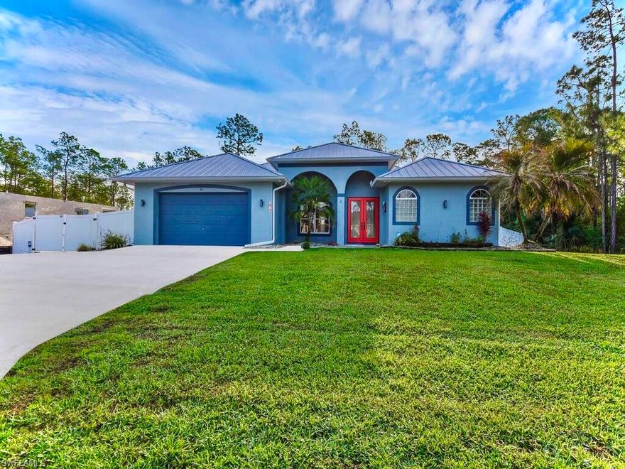 Welcome to the this Magnificent over 2,100 sq ft  3/3 waterfall HEATED POOL home on 6ft fenced half acre with an enormous insulated 30 by 50 DETACHED BUILDING including 12 & 15 ft roll up doors! This property has been freshly painted & nicely landscaped spotlighting GRAND elevations of high ceilings with 8ft pocket sliders & DOUBLE door entrance, refreshing big bay windows, a luxurious LEATHERED granite breakfast bar, and an impressive (2021) METAL roof. This split plan plan with DUAL SUITES also highlights NEW pool heater & water softener system, attractive glass tiled backsplash, recessed & pendant lighting, a desirable jetted soaking tub, instant hot faucets, rewarding dual sink vanity, and a massive WALK-IN closet. It is tiled throughout & also features new wood plank tile, an oversized 2 car garage, whole house gutters, tiled walk-in shower, video security system, plant shelving, an accommodating back patio under trust, pantry, faux blinds, Fruit trees, and the laundry room is under with vanity sink & storage cabinets. It is nestled away on a quiet street just minutes to all major amenities & a quick commute to Fort Myers. Schedule your private showing today!