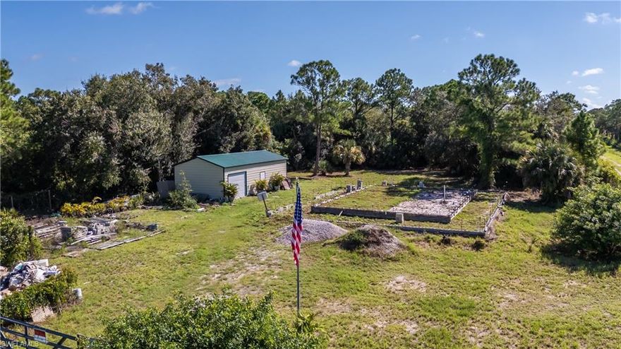 Investor Special – 1.25 Acre Fenced Corner Lot with Shed & Foundation.

Bring your vision to life with this fully fenced 1.25-acre corner lot in Montura Ranches, mostly cleared and sitting higher than neighboring parcels for better drainage and privacy.

The property includes a 41x18 shed, offering ample storage for tools, toys, or materials, with potential to add electric and water for the ultimate workshop, man cave, or she shed. An existing foundation is in place for a planned 3-bedroom, 2-bathroom concrete block home, designed for 2,928 sq. ft., including a wraparound porch. Imagine sipping your morning coffee or watching the birds sing from the planned wraparound porch, taking in the peace and privacy that Montura Ranches is known for. With the foundation already in place, you have the opportunity to pick up where the builder left off, finishing the home to your exact style, finishes, and preferences for a truly custom build..

Montura Ranches offers the perfect balance of rural privacy and convenience. You’re just 65 miles to Fort Myers and 95 miles to Miami, with easy access to I-75, I-95, RSW, and MIA airports. Weekend trips to both Gulf and Atlantic beaches are within easy reach, giving you the best of both coasts.

With no HOA and true freedom to bring farm animals, RVs, or ATVs, you’ll enjoy unmatched flexibility while still having access to great amenities. The community features a clubhouse, pool, playground, basketball, volleyball, baseball field, kids’ park, and outdoor fitness park, a rare blend of independence and shared perks.

This is a unique chance to secure a fenced, improved lot with a foundation in place at a reduced price, perfect for investors, builders, or anyone looking to create their dream homestead in Montura Ranches.