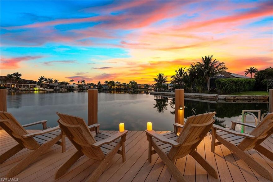 In the extremely popular River area of Marco Island, renowned for its quick, direct Gulf access via the Marco River, this stunning four-bedroom plus den, 4.5-bath custom-built residence offers over 5,100 square feet of refined living space and is a showcase of luxury and elegant coastal design. With western-facing bay views, enjoy breathtaking sunsets and expansive water vistas from nearly every room. Upon entry, you’re welcomed by a dramatic custom glass-inset stainless steel front door that opens to a grand foyer and expansive great room, complete with a gas fireplace wrapped in stone, custom built-in cabinetry, porcelain floors, backlit tray ceiling and a multi-zone audio Sonos surround sound system. The chef-inspired gourmet kitchen features quartzite countertops and backsplash, top-tier appliances including a Viking six-burner gas cooktop with pot filler and a Sub-Zero refrigerator/freezer. A large island, Viking hood, under-cabinet lighting and a dedicated coffee bar complete the space. Adjacent are the breakfast nook and formal dining area. The den offers a refined setting, with coffered ceilings, recessed lighting, built-in desk and integrated speakers. The luxurious primary suite offers French doors to the lanai, backlit tray ceiling, transom windows and integrated ceiling speakers. The spa-like primary bath includes a jetted Kohler tub overlooking the garden, quartz vanities, an oversized walk-in shower with rain and body sprayers, a private water closet with bidet and a spacious custom closet with center island. All guest bedrooms feature en-suite baths, balcony access, tray ceilings, recessed lighting and Kohler walk-in showers. Upstairs, a wet bar with beverage refrigerator and microwave adds convenience, while a recreation room above the garage brings fun with a pool table, shuffleboard, poker table, entertainment center, built-in speakers, and its stackable washer and dryer. Outdoor living is elevated with a heated pool and spa showcasing a tile waterfall, sunken bar with beverage refrigerator and stainless cabinetry, outdoor shower and LED lighting. The spacious lanai features roll-down hurricane shutters and matching paver decking that extends to the dock. Boating enthusiasts will love the 7,500-pound boat lift, 12,000-pound PWC lift platform, wide bay views, and dock space with a fish-cleaning station and water access for kayaks and paddleboards. This home is equipped with smart home technology, a full-house generator and a 1,000-gallon propane tank. Additional features include a built-in dehumidifier system for optimal indoor air quality. The home was quality-built by Slocum-Christian, known for its craftsmanship. A four-car garage with workshop, mini-split air conditioner, storage loft, ceiling fans and room for all your needs of this meticulously crafted residence. Experience premier island living!