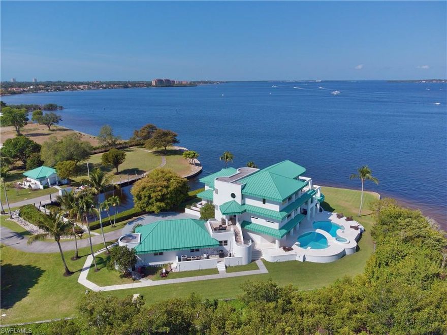 One of SW Florida's Crown Jewels!!! This amazing 5.7 acres gated waterfront estate, located on the point of a peninsula, with incredible views like no other. Deepwater boat basin dock area that will accommodate your luxury 100 ft+ yacht & any other watercraft of your desire. Long western exposure views w/sunsets every day. The home was recently enhanced with a new kitchen, baths, flooring & is nearly 7000 sq ft of living w/ incredibly large lanai & deck space off every room. New impact windows and doors, newly enhanced pool & spillover spa area w/ huge open-shell stone deck space. Enjoy a panoramic setting w/over 1,000 ft of water frontage. Lots of room to build a guest house, design & landscape your own par 3 holes on the water, land your helicopter on your own private pad, keep your car collection on-site & build your own private storage, & more. Close to open bay and gulf waters and world-renowned Sanibel/Captiva beaches. You can have it all w/one of SW Florida's premier trophy properties.