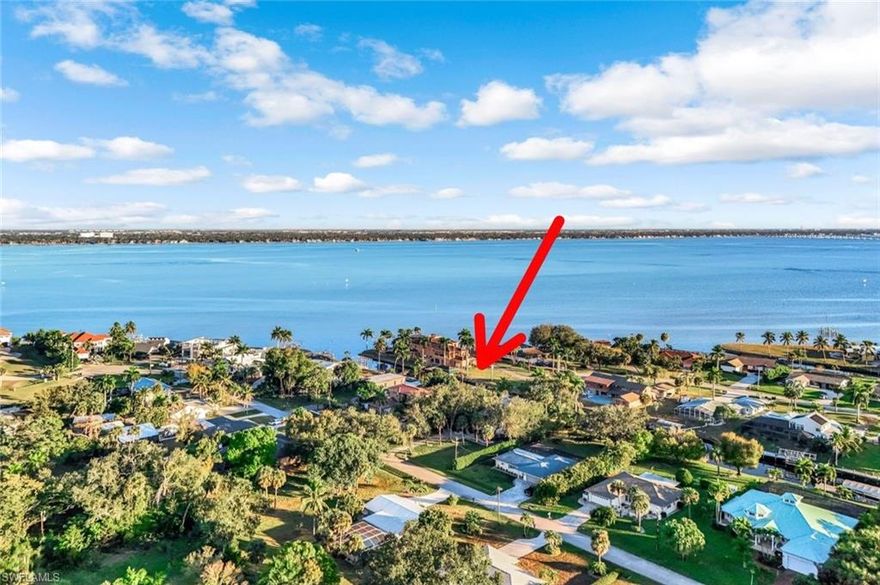 Hidden under a canopy of mature live oak trees, sabal and coconut palms, this waterfront retreat offers the kind of lifestyle boaters dream about—direct access in under a minute to the Caloosahatchee River and open Gulf waters. Nestled on a half of an acre, and positioned perfectly for both privacy and spectacular views, you’ll fall in love with the peace and tranquility you feel from the moment you arrive. 
The charming Craftsman-inspired front porch looks like something out of a fairy tale! Inside, this home immediately sets a warm, welcoming tone filled with natural light thanks to vaulted ceilings, skylights, and multiple sets of French doors, creating a space that naturally draws you in to relax or gather with friends and family. The freshly painted interior, along with plantation shutters and crown molding are elegant upgrades that reflect the care and pride of ownership in this home.
 
The high-end kitchen is an entertainer's dream, with modern appliances, a wine cooler, a reverse-osmosis faucet, and soft-close cabinetry. 
Step outside and you’ll find your own backyard oasis: a remodeled pool and deck, custom lanai lighting, and an outdoor shower. In fact, multiple outdoor living areas designed for relaxation and gatherings are what make this property truly special! From the screened-in lanai, to the outdoor deck, brickpaver patio, boat dock, and TWO upstairs balconies, you’ll always space to take in the sounds of nature and enjoy peaceful water views.

For boating enthusiasts, the private dock and new boat canopy make it easy to be on the water in minutes. This home has not had water intrusion from past storms. 

This is more than a waterfront property—it’s a place to slow down, entertain, and fully embrace the Florida boating lifestyle in a setting that feels both refined and welcoming.