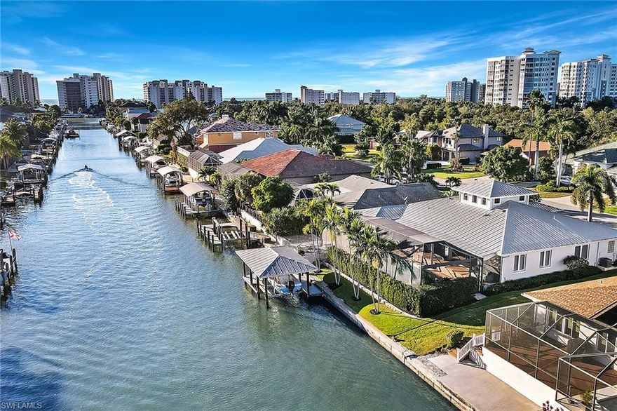 A rare offering in this market. Beautiful waterfront, move-in ready and well-priced home in Naples. This immaculate home will not last. South-facing property on one of Conners' best streets boasts expansive views, lush landscaping, a large waterfront pool, sun deck and covered boathouse. Over 2,600 square feet of high-quality construction includes three bedrooms, two-and-a-half baths, den, gourmet kitchen, open living spaces and vaulted ceilings. This impeccably maintained home features custom built-in cabinetry, cypress ceilings, wood and stone flooring, a propane fireplace and a metal roof. Prime North Naples location close to world-class dining, golf, tennis and fabulous shopping. Walking distance to a spectacular beach. An amazing opportunity to start living the Naples waterfront lifestyle!