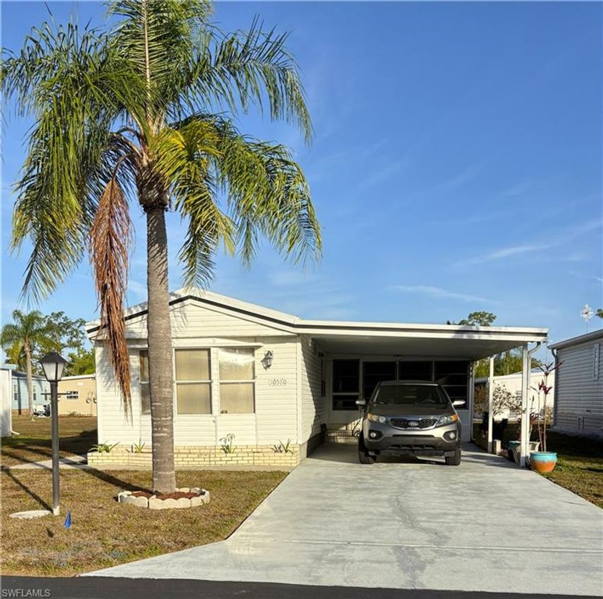 Huge price reduction!  Welcome to Bonita St. James!  Lovely Bonita Springs 55+ co-op community.  Fees ONLY 95.00 per month. Community offers boat and RV storage (for a small fee). Fiber Optics is on the way.  NOT IN A FLOOD ZONE!
Offered Turn Key.  Just bring your toothbrush.  Vehicle also available for separate purchase.  
1064 square feet of living area, attached carport, 2 bedroom, 2 full baths, extra bonus living area, workshop AND storage space.  New fans, flat screen TV,  commodes in both baths, roof resealed and HVAC serviced in 2025.   Needs some updates, but all is functional, and home is priced accordingly.  As Is.  Cash only please.