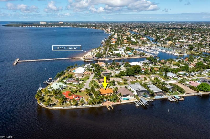 Think outside the new construction boxy style and enjoy your new home now!  No need to wait 1-2 years to build your dream home.  Wake up to a Million dollar view with this beautiful RIVERFRONT home located 1 lot from the TIP of Cape Coral.  Walking distance to the Cape Coral Beach - Yacht Club and enjoy a few cocktails & sunset at the Boat House Bar/Restaurant!  See Plans from City to Renovate and expand the beach!  This Tuscan Style Villa was constructed with only the finest materials featuring a grand entrance, split floor plan with 4 large bedrooms + Den and 4 full baths. All bedrooms and den enter their own private terraces! The Lot is fully fenced with rod iron lush landscaping and one of a kind open air pool. Do you enjoy cooking... come and see this massive Thermador Gas Range/Indoor Grill equipped with dual ovens, stainless hood, 4 burners, grated grill and flat top for perfect pancakes! This kitchen would not be complete without the massive Twin Jenn Air Refrigerators.  Enjoy the sunset and relax around the resort style pool with waterfall and hot tub. Furnished with Robb & Stucky and furniture is Negotiable with the sale. Come and scheduled your private showing today!!