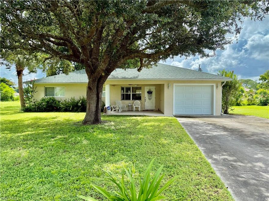 Affordable 3 bedroom 2 bath with an oversized one car garage, the home was completely built over again in 2006, new everything, NEW DIMENSIONAL SHINGLE ROOF IN 2023, NEW CENTRAL HEAT AND AIR IN 2023, CENTRAL WATER, oversized yard with small oak trees for shade and a fenced dog run area, quiet low traffic street, extra long driveway with plenty of parking, cathedral ceilings, covered front porch plus a 24 X 14 screened lanai overlooking the backyard, newer insulated windows in 2006, new electrical and plumbing in 2006, GUARDIAN AUTOMATIC GENERATOR WITH GAS HOOK UP, solid surface counter tops in the kitchen and baths, all appliances in kitchen, laundry area in garage with washer and dryer, laundry tub, new panel doors on the interior, primary bedroom with walk in closet and private ensuite bathroom with walk in shower, TERRRAZZO FLOORS UNDER CARPETING, walking distance to stores and schools and just minutes to I-75, Ft Myers and SWFL International Airport. NO FLOOD INSURANCE REQUIRED. LEHIGH IS THE HIGHEST ELEVATION IN LEE COUNTY.