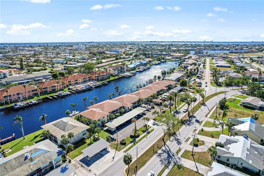 This beautiful move-in-ready gulf access condo is located on the desirable Rubicon Canal. The 2-bedroom 2- bathroom first floor unit has been completely remodeled with zero expenses spared. The work has been done for you and features a spacious kitchen with upgraded white wood shaker cabinetry, stunning quartz counter tops with tile back splash, and stainless-steel appliances. Crown molding throughout the unit and wood-like flooring throughout the main living area and one bedroom, tile in bathrooms and carpet in the bedroom; there is also fantastic space that can be used for an office/storage area! The master bathroom features an elegant walk in shower with new tile and river rock flooring. Both the living room and the master suite lead to the spacious tiled lanai with sliding glass doors that disappear into the walls for that open floor plan with great water views. Experience paradise in this amazing condo!