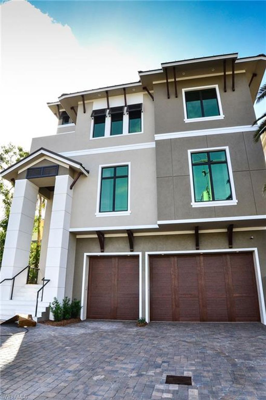 Construction is now complete on this direct Gulf front residence. The main living level includes two private guest suites w/ full baths, guest laundry, custom bar w/ seating, and a stunning gourmet kitchen that includes a gas range, breakfast bar & butler's pantry. The great room offers intricate ceiling detail & pocketing sliders to allow for panoramic Gulf views. An elevated pool & spa can be found off of the main living level with glass railings to maximize Gulf views, outdoor kitchen, and convenient pool bath. The 3rd floor features the master bedroom, bonus/entertaining room, study/home office & full bath. The master bedroom includes a private lanai, fireplace and a spacious bathroom w/ automated toilet, walk-in shower w/ seamless glass door & multiple shower heads. The bonus room features custom bar, gorgeous wood lined ceilings, & lanai overlooking the Gulf of Mexico.  Six car plus garage.  A stunning beach home!