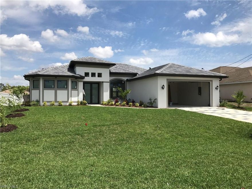 BRAND NEW 2017 POOL HOME Cape Coral with all the upgrades you've been looking for! This 3 bedroom, 3 bath home features gorgeous 8-foot double doors, a spacious great room with high tray ceiling, 24-inch tile all throughout home, 7.1/4 inch tall baseboards, and 90 degree glass sliders that look out onto the pool lanai. This home has been designed for gracious living and entertaining. The Kitchen boasts wood cabinets with soft close doors, beautiful granite counter tops, and stainless steel appliances. The lanai area and pool cage are very large, featuring the custom saltwater pool. Master bedroom is very spacious with his & her sinks and walk around shower. A few added features that you will enjoy with this home are the Impact Hurricane Windows, LED lights, ceiling fans throughout the home, pavered driveway, and much more!