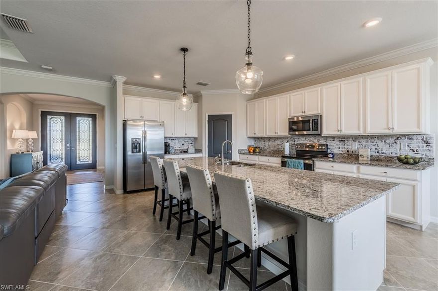 MOVE-IN READY, No 8 month wait!!!! Summerville II model with over 2,445 sq ft of living space featuring 3 bedrooms + DEN, 3 FULL baths PLUS the 3-car garage with additional storage space. SPACIOUS open kitchen has granite countertops, walk-in pantry, HUGE island bar & eat-in kitchen PLUS ceiling fans in all bedroom, LRG 60"ceiling fan with remote in family room, NEW pendants over island, NEW light fixture over dining table, Faux white washed brick wall treatment on dining room wall and back splash, vertical pleated blinds on family sliders, room darkening vertical pleated blinds in master bedroom on slider, ALL interior doors painted in accent color. Don't miss the incredible sunsets on this eastern facing lot, which is no longer available from builders! The Place at Corkscrew is a 5-Star Resort including fitness center, childcare room, market/café, spa, tennis & pickle ball courts, bocce ball, dog park, fire pits, sand volleyball,lakeside beach, HUGE pool deck surrounding free-form zero-entry pool with custom rock waterfall & slide, basketball area, picnic pavilion with playground, full service restaurant & lounge! Like no other in this area! Call today.