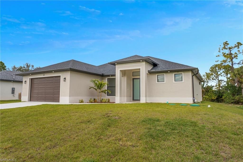 Photo of 717 Theodore Vail ST E, LEHIGH ACRES, FL 33974 (MLS # 226005542)