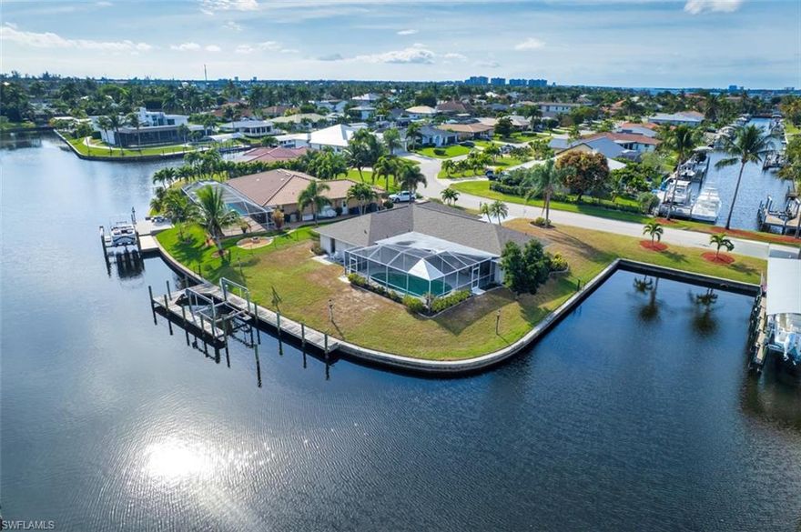 Nestled in the highly sought-after Town and River Estates, this exceptional waterfront home offers sailboat access to the Caloosahatchee River with quick access to the Gulf. Positioned on two sides of water, the property boasts multiple dockage opportunities, complete with a boat lift and wraparound wooden dock.
The recently remodeled 3-bedroom, 2-bath home features an open living and dining area, a spacious family room, and a separate laundry room. Step outside to a screened-in swimming pool ideal for waterfront living. The home has been upgraded with a brand-new kitchen and baths featuring shaker-style cabinetry, new countertops, and updated vanities. A 2-car garage completes this outstanding waterfront retreat.
