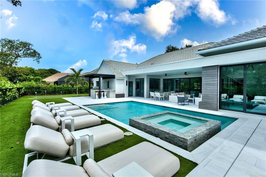 Welcome to Paradise! Ready to experience your cozy home in the amazing Pelican Bay community with a private beach, ocean front restaurants, water sports, a golf club, gym, tennis courts, and much more? Picture yourself in this state of the art gem designed by HLevel and built by the high end builder BellaMia.  Extended warranty period by builder. This includes 4 bedrooms + a den/office, 3.5 baths, and everything designed with exclusive taste. You will love the vaulted ceilings, bathrooms and every corner of this home. Custom Italian imported Kitchen and closets. Top of the line appliances: Jenair, Miele built-in Coffee maker and wine cooler. Expand your lifestyle, relax and catch the sunset in the spectacular and spacious outdoor area with a custom and trendy marble pool deck and a provocative swimming pool with spa. Covered pergola grill area with high end appliances and wet bar to enjoy your family BBQ, facing a huge patio area with artificial grass and flexibility to create different setups for enjoyment, in addition to a cool golf putting green. Your new home is a combination of modernism and elegance with everything TOP of the line to make your greatest visions come to life.