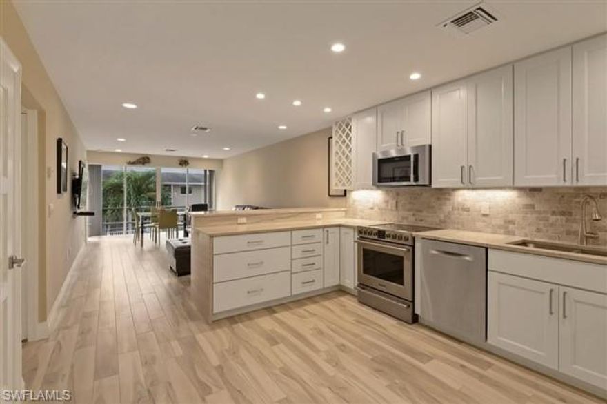 Boaters paradise! Enjoy your deeded, 25-foot dock with this contemporary, 2-bedroom, 2-bathroom unit on the top floor of a two-story quiet, waterfront building only yards from Naples Bay. Newly-remodeled with brand new kitchen appliances, hurricane impact windows, air conditioner, electrical, ductwork, and full-size washer and dryer. Granite countertops in kitchen and bathrooms. Durable, porcelain wood-look floors. Recessed LED lighting throughout. Walk-in closet in master bedroom. Linen closet in master bath. Decorated with brand-new furnishings. Newly-remodeled, heated pool. Walking distance from Downtown Naples, 5th Avenue, Tin City, Naples Bay Resort & Marina.