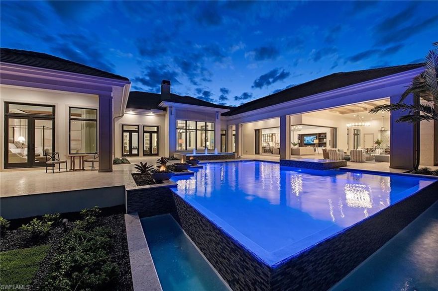 The Coquina model by Stock Custom Homes is now completed in the exclusive Estates neighborhood in Estuary at Grey Oaks. This custom home conceived by RG Designs along with Marc Michaels Interior Design resides on an oversized 0.81-acre homesite with gorgeous long-range golf views through nearly every room of the residence. The four bedroom plus club room, four and two half bath model has soaring ceilings and a spacious open concept floor plan that exudes quality throughout. The custom gourmet kitchen with top of the line Wolf and Sub-Zero appliances has a generous island with dual dishwashers. This home is perfect for entertaining family and friends and has a spacious butler’s pantry, bar, open see-through glass climate controlled wine room and a dining room with French doors overlooking the pool area. The outdoor living space takes full advantage of the Naples indoor /outdoor lifestyle with a custom designed pool and 360-degree spillover spa, gas fireplace, outdoor fire pit, all enclosed with hurricane shutters and motorized screens at the touch of a button. A world of luxury awaits you in the private country club community of Grey Oaks.