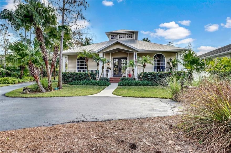 Reduced! Magnificent Key West style home in Livingston Woods surrounded by lush tropical landscape and tranquil backyard with resort style pool and spa and detached chickee-hut.  Soaring cupola and abundance of natural light welcomes you to this beautiful home with four bedrooms, three bathrooms and detached two car garage. Home is beautifully decorated and fully upgraded including: bamboo flooring, vaulted ceilings, remodeled master suite with oak flooring, his and her quartz counters, frameless walk-in shower and walk-in closet. Second bathroom with quartz counters and frameless shoer, two new A/C units, metal roof, updated kitchen with granite counter tops, designer cabinets and reverse osmosis water system. Bonus room with separate entrance, living-room, bedroom and bathroom. Screened-in lanai with outdoor bar. Then Paradise found right in your own backyard featuring an oasis with heated pool, spa and chickee-hut perfect for entertaining or just enjoying the tranquil Florida nights