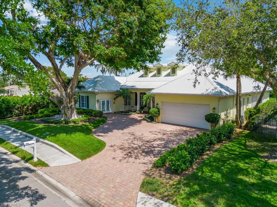 This gorgeous single level home was purposefully built at a higher than normal elevation in 2002. Introducing 505 Harbour Drive, a Olde Florida style home located in the Moorings. This charming residence is the epitome of coastal living, featuring a timeless design that exudes warmth and sophistication. As you approach the property, you'll be greeted by lush tropical landscaping and a welcoming front porch. The interior boasts an open and spacious floor plan, with plenty of natural light streaming in through large windows. The chef's kitchen features gas range, stainless steel appliances, custom cabinetry, ice maker, wine fridge, walk-in pantry and a large island perfect for meal prep or casual dining. There are two en-suite guest bedrooms that are generously sized, and offer plenty of closet space. In addition, there is another bedroom or office with a full bath and a den with 1/2 bath, perfect home office area or guest suite.  The primary suite is a true retreat, featuring soaring ceilings, French doors leading out to the lanai, 2 generous walk in closets, dual vanities, a soaking tub, and a walk-in shower. Located just a short distance from the beach and downtown Naples, this home offers the perfect combination of luxury and convenience. MEETS FEMA ELEVATION REQUIREMENTS