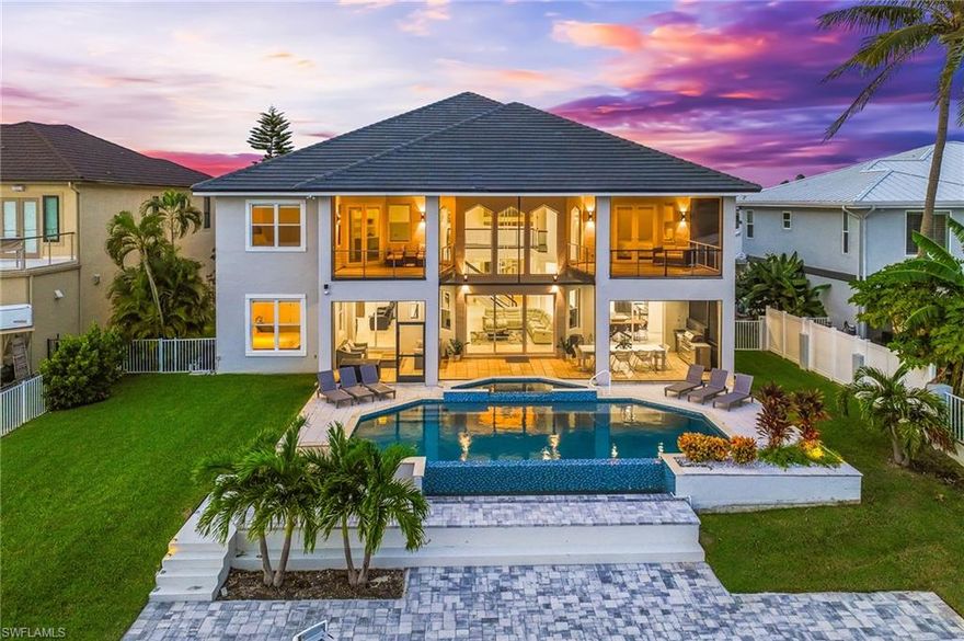 Step into timeless sophistication with this breathtaking riverfront estate, a residence that seamlessly blends modern luxury with effortless coastal living. Meticulously remodeled in 2022 and offered furnished, this home invites you to begin living the signature Florida lifestyle from the moment you arrive.

Boasting 5 spacious bedrooms plus a den, 5 and a half luxurious baths, and a 4-car garage complete with an air-conditioned workshop, every inch of this property has been thoughtfully crafted to deliver elegance, comfort, and functionality. A new tile roof, impact-resistant windows and doors, and a chef’s kitchen showcasing exquisite quartz surfaces, a waterfall-edge island, and curated cabinetry elevate this home into a class of its own.

The expansive great room is drenched in natural light, showcasing panoramic views of the River through walls of glass. A double-sided fireplace anchors the space, creating a warm ambiance ideal for intimate evenings or elegant gatherings.

Two grand master suites offer the ultimate in privacy and indulgence—each with a screened in private balcony, spa-inspired baths, freestanding soaking tubs, and custom walk-in closets. Floor-to-ceiling windows frame uninterrupted river views, evoking the serenity of a private resort.

An elevator ensures ease of access to every level, while a state-of-the-art media suite—complete with a full bar—provides the perfect venue for entertaining, movie nights, or can serve as a private guest or in-law suite.

The outdoor living space redefines relaxation and recreation with a heated infinity-edge pool, spa, and multiple areas for open-air lounging and dining. For the boating enthusiast, this property is a dream come true—featuring a new 20,000 lb. boat lift and a Trex captain’s walk dock that accommodates large vessels with ease.

Beyond its architectural beauty, this home also presents a remarkable investment opportunity. Operating as a high-end, income-producing Airbnb, it has hosted full weddings and exclusive events, consistently attracting luxury clientele drawn to its blend of elegance, privacy, and waterfront allure.

With its captivating riverfront setting, masterful design, and unrivaled amenities, this residence embodies the pinnacle of Southwest Florida luxury living—an exquisite sanctuary offering both an extraordinary lifestyle and exceptional income potential.