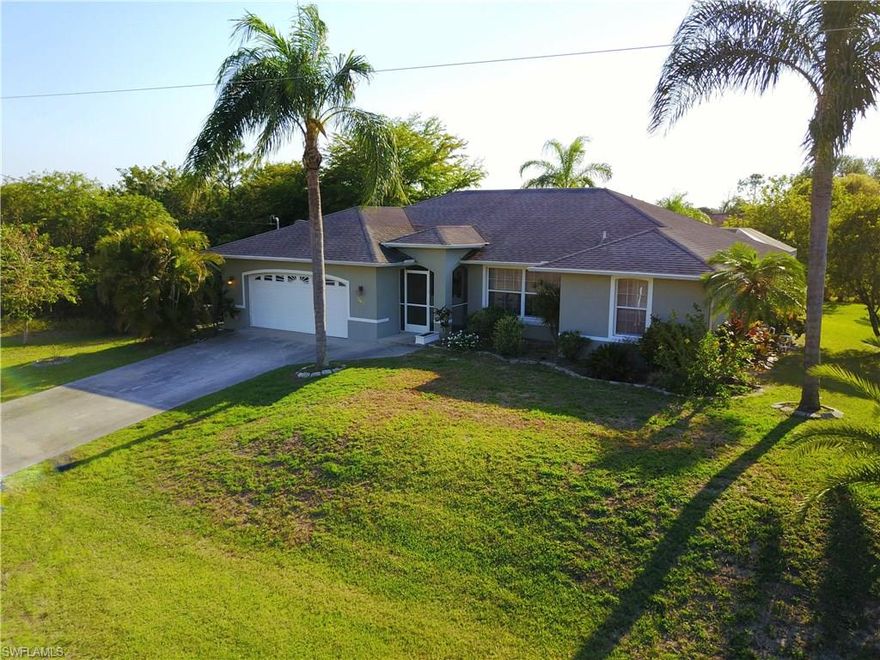 Come check out your own piece of paradise with this 4 bedroom waterfront pool home located just outside Mirror Lakes Golf Course. This beauty has recently underwent updates and upgrades such as fresh paint and a remodeled kitchen with granite counter-tops, solid wood cabinets and stainless steel appliances (Washer and dryer also included!) In three out of the 4 bedrooms you will find walk-in closets for tons of extra storage room and the layout boasts separate living, family and dining rooms. The master bath has dual sinks and a large soaking tub to relax and master bedroom features direct access to the pool area where you can rest under the shaded screened lanai. Guest bathroom has a dual entrances and cultured marble solid surface counter-tops. The well manicured yard features a new storage shed, landscaping and mature palms and an area that is fenced on the side, perfect for pets. Over-sized rear yard directly overlooks a large intersecting peaceful canal that is great for fishing. Located just minutes away from schools and easy access to shopping and restaurants. You wont find many homes like this for the price, call now!