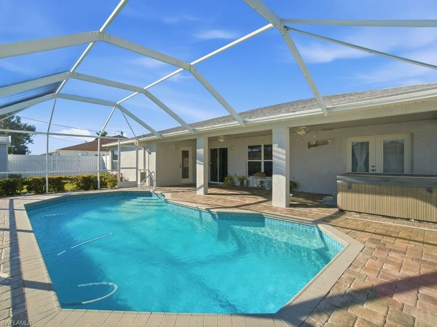 Move-in-ready pool home in highly sought-after Southwest Cape Coral! This one-owner, custom-built home offers 3 bedrooms + den + formal dining room across 2,242 sq ft and delivers incredible flexibility and the den and/or dining room can be easily enclosed to create a 4 or even 5 bedroom layout, making it perfect for growing families, multigenerational living, or maximizing rental income. Pride of ownership is evident throughout, with fresh interior paint and a bright, open floor plan. Tile flooring runs throughout the main living areas, while the bedrooms and flex spaces feature comfortable carpeting. The kitchen features stainless steel appliances, ample cabinetry, and a cozy breakfast nook overlooking the pool area. The split-bedroom layout provides privacy, and the oversized guest bedrooms are larger than most homes on the market and are increasingly rare to find. The primary suite offers French doors leading to the lanai, creating a true private retreat. The guest bath doubles as a convenient pool bath, ideal for entertaining. Step outside to your private backyard oasis with a screened-in pool, expansive covered lanai, and a 5-person hot tub that’s perfect for enjoying Florida living year-round. The fully fenced yard, mature landscaping, and storage shed add both privacy and functionality. Additional highlights include a 2-car garage and a transferable NFIP flood insurance policy at just $1,972 annually. A significant savings compared to current policies. Located between Veterans Parkway and Cape Coral Parkway with quick access to shopping, dining, downtown Cape Coral, and Fort Myers. Homes with this level of flexibility, condition, and outdoor living are in high demand and do not last. With the ability to easily convert to 4–5 bedrooms and strong appeal for both end-users and investors, this property is positioned to sell! So don’t wait!