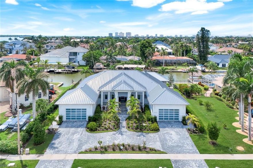 Completed in Oct 1, 2024 by renowned Coastal Build, this recently built custom Caxambas waterfront residence blends modern coastal sophistication with timeless elegance. Set at 12' elevation on a 125' waterfront site just four homes from Caxambas Pass, the property offers immediate Gulf access with waterfront views. Ideal for yachting or boating enthusiasts, the home is designed to capture the Florida lifestyle with sunlight pouring through walls of 10' impact sliders effortlessly framing the water. The home opens with a broad front porch, a timeless space for rocking chairs and quiet moments of elegance. Inside, the walls are finished in sun-washed, neutral tones that flow seamlessly from room to room. Refined finishes include wide-plank tile flooring, custom designer lighting, and shiplap wall accents, with tray ceilings with wood beams that flow from the open living spaces through to the lanai. The chef's kitchen features a custom gorgeous tile backsplash, Wolf 6-burner gas range with griddle, pot filler, ceiling-height cabinetry, and a full butler pantry nearby with coffee bar for seamless entertaining prep. The spa-like primary suite features an expansive shower with 2 shower heads and bench, with desinger extra large plank tile, a freestanding tub, twin vanities, plus cosmetic station, dual walk-in closets and a private patio with waterfront views for the owner's retreat. Outdoor living is extraordinary with covered lanai's finished in beadboard inlay, natural stone tile flooring, automatic sun screens, a full summer kitchen, and a resort pool with sun shelf and an integrated zero edge waterfall spa. An expansive 2367sf of outdoor elegance includes an outdoor shower and 1/2 pool bath. Enjoy spectacular sunsets and evenings around the cozy dedicated firepit overlooking the water. A boat lift, jet ski lifts, and an tremendous dock system make boating a dream. Hurricane-rated windows and doors, automatic sun screens (see out, not in), a whole-house 24k gas generator, and an aluminum roof rated up to 225mph provide peace of mind. Offered furnished in a refined coastal-chic style, this residence captures the pinnacle of Florida waterfront living—where sun-drenched days, yachting adventures, and effortless luxury come together for discerning buyers who expect nothing less than the best.