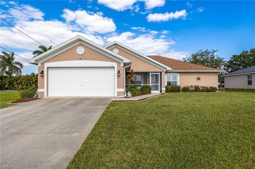 IMPRESSIVE!  Large home in beautiful NW Cape Coral! This spacious and meticulously maintained property shows what Pride of Ownership is all about! This home is a must-see, featuring valuable upgrades making it the perfect blend of comfort, style, and functionality.  You'll agree it's ideal for a growing family or anyone looking for extra room to spread out. Size matters in this 3-bedroom, 2-bath home, PLUS a den and a formal dining area, offering over 2,000 square feet of living space under air, featuring a desirable split floor plan for added privacy. Built in 2004, pride of ownership is evident throughout, with the custom Waynscott molding throughout the entrance, dining, and living area, with numerous updates and upgrades already completed!  The open kitchen features granite countertops, shaker-style cabinets, extended cabinetry into the dining area with a built-in hutch and coffee bar, stainless steel appliances, and, with the remodel, the kitchen overlooks the living area for entertaining and continued conversation. Large primary suite with a completely remodeled ensuite bath, including a floor-to-ceiling tiled walk-in shower and an added linen closet. Interior and exterior recently painted.  Additional upgrades include a new roof (12/2022), impact windows (5/2022), an AC system (2020), an enclosed front lanai (5/2022), and a new fence (12/2022), a finished garage floor with added GENERATOR plug and go set up, and Wood Grain LUX VINAL throughout the home. Home is on well and septic with a bonus whole-home water filtration system for reduced utility costs, better tasting water, and less wear & tear on pipes. Exterior features a sprinkler system, fully fenced backyard, fire pit area (ELECTRIC OUTLETS), a custom stamped concrete walkway, and updated front and rear lanai flooring to match. The screened front sitting area even offers additional outdoor living space. Great location across from a large open field owned by the school board with no current plans for development, providing added privacy. Move-in ready and ideal for families or those seeking the perfect home to spread out & entertain guests!