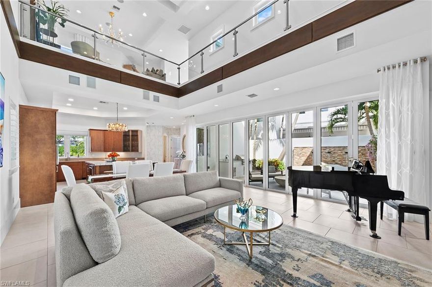 Located within the gated community of The Residences of Mercato, this beautifully updated home offers a opportunity just steps from Mercato's dining, shopping, entertainment and minutes from Naples beaches. The residence features curated updates throughout, including new lighting, custom wallpaper, draperies, furnishings and fresh interior paint. The gourmet kitchen is equipped with premium appliances, drawer style storage and a custom glass front cabinet ideal for display and entertaining.  The primary suite, privately located on the main level, provides a comfortable retreat, while the second floor offers four guest bedrooms each with an ensuite bath, one which is a versatile office featuring custom built in shelving. Additional  conveniences include an air-conditioned garage with added storage, a spacious laundry room and a while house generator. Outdoor living includes a private lanai with an outdoor kitchen, pool and a tranquil water feature, creating a relaxed setting for entertaining or everyday enjoyment. Combining thoughtful design, functional upgrades, and an exceptional walkable location, this residence offers a low-maintenance luxury living in one of Naples most vibrant communities.