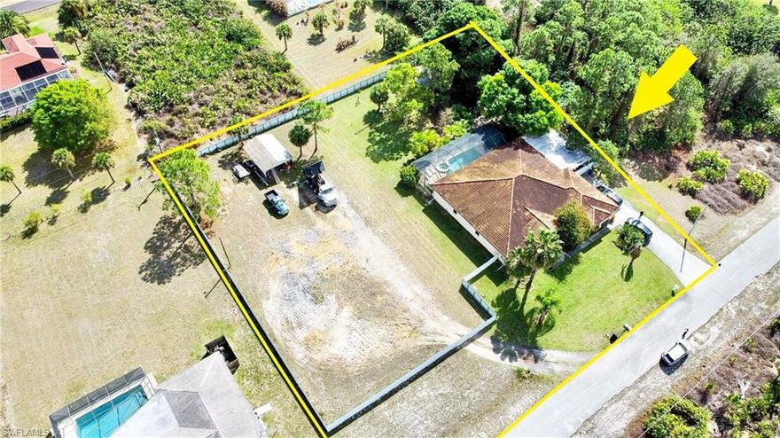 This Florida Beauty Ranch Style Home is a Must See! Sitting on a completely fenced Full 1 Acre in the heart of Lehigh providing privacy and convenience at the same time. This home boasts over 2,300+ square feet living area, including 3 bedrooms plus a den/office and 2 full baths. Vaulted ceilings throughout with an open floor plan to the Split Bedrooms and a Grand Master Suite with his and hers closets. The interior of the home features a chef inspired granite kitchen, custom pantry with slide out organizers, island, breakfast bar, formal dining room, family living room, and a dedicated laundry room. Unwind as you step into the spacious and enclosed lanai with a heated Pool and Jacuzzi, fully equipped outdoor kitchen, soft top canopy, and panoramic views of the oversized beautifully landscaped yard...You will want to see this home before it's gone!