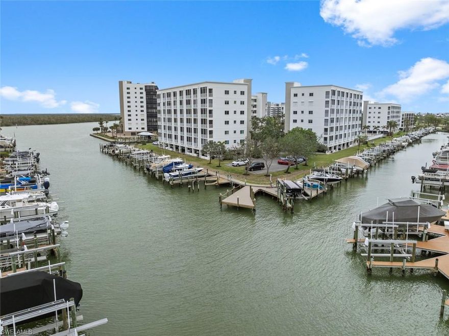 BOAT DOCK INCLUDED IN THE PRICE! Short Term Rentals Allowed!  BEAUTIFUL BAY VIEWS! This stunning 2-bedroom, 2-bathroom condo offers breathtaking views of the main channel and bay, complete with a private boat dock and lift included. Watch dolphins, manatees, and boat parades right from your expansive lanai, which spans the length of the unit and can be accessed from both the living room and primary bedroom. The interior features tile flooring in the main living areas, carpeted bedrooms, and a fully updated kitchen with modern countertops, a stylish backsplash, and recently updated appliances, including a refrigerator, dishwasher, range, washer, and dryer. Both bathrooms have been beautifully renovated, and a new AC was installed in 2023. The included boat lift accommodates a boat or jet ski, with water and electric hookups at the dock, everything is brand new. Community amenities include a heated pool, deeded beach access, a fishing pier, and Bay Beach Commons with pickleball courts, a putting green, tennis courts, and a serene park-like setting. This condo is the perfect blend of modern comfort and waterfront living—schedule your showing today!