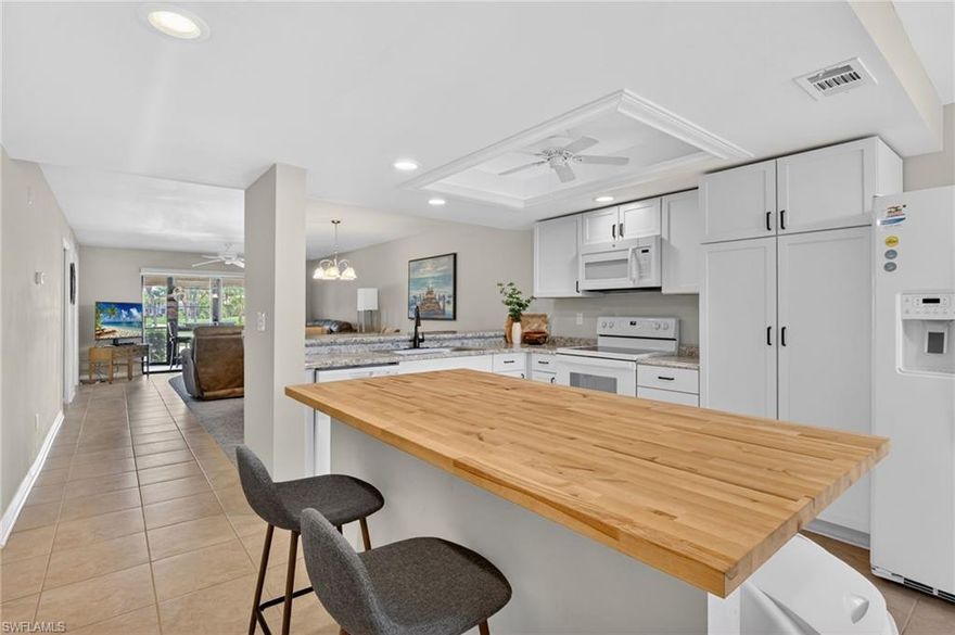 Welcome to Kelly Greens Golf and Country Club!  This totally remodeled 1st floor unit features an open concept floor plan, complete with a center island.  The kitchen boasts white shaker cabinets and granite countertops.  The lanai looks out at the 16th fairway and 17th tee box, with no other condominiums in sight.  The primary and guest bathrooms have been updated, and each has a walk-in shower.   The roof was replaced in 2024 and the building was painted in 2025. and Manor I has flood insurance included in the HOA!  Kelly Greens Golf and Country Club's prime location offers easy access to Sanibel Island, Fort Myers, and Bunche Beaches, making it a highly desirable place to live. Kelly Greens boasts a championship golf course, Har-Tru tennis courts, a fully remodeled clubhouse and a new fitness center. The dedicated and knowledgeable staff, including management, administrative, pro shop, accounting, restaurant, cart barn, and maintenance teams, are always ready to assist members, guests, and tenants. Don't miss the opportunity to own this exceptional home in a premier location, offering a luxurious lifestyle and peace of mind. Schedule your visit to 12191 Kelly Sands Way Unit #1505 today and discover all that this remarkable property has to offer