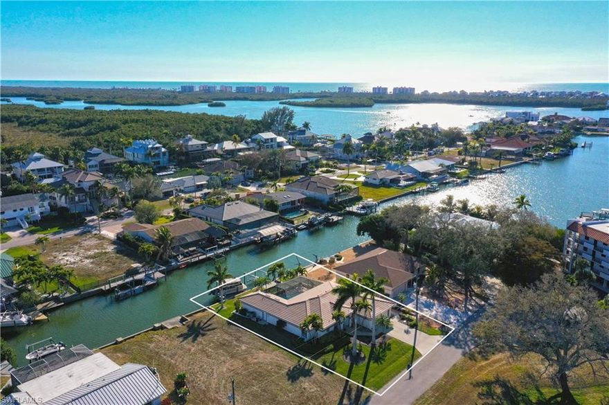 This completely refashioned Collier County waterfront home is the perfect blend of luxury, location, and lifestyle, a Boaters’ dream!  This stunning home features a completely refashioned interior and exterior. The designer-renovated interior boasts tile floors throughout, designer lighting and ceilings fans, and custom window treatments. The chef’s kitchen is a showstopper with custom cabinetry, quartz counters, custom backsplash, stainless steel appliances, and a large island with seating. The spacious master suite offers a custom designed bath with a large shower and finished walk in closet. Step outside to your private lanai that connects the pool area to the waterfront. Enjoy 2 boat lifts (#8500) up to 24’ and (#13,500) up to 35’ direct Gulf access with no bridges. NO HOA restrictions! The attached guest house is perfect for extended family and friends. This home is complete with a (2024) HVAC, (2024) tile roof and electric storm shutters. Located in the sought-after Little Hickory Shores boating community, this home is just minutes from Barefoot Beach, shopping, restaurants, grocery stores, fitness centers, and beautiful white sandy beaches. Whether you prefer to walk, bike, or boat, this is paradise.