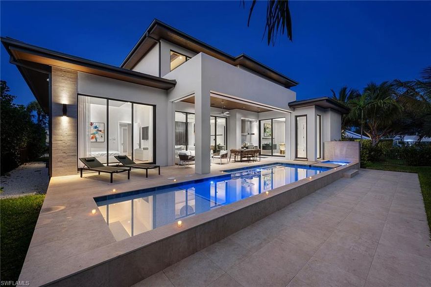 NEW CONSTRUCTION | NEVER LIVED IN | PRIME OLD NAPLES LOCATION. Just completed in 2025 by one of Naples’ most celebrated architectural firms, H-Level, in collaboration with top-tier international design teams and Alair Homes of Olde Naples, this breathtaking modern masterpiece sets a new standard for coastal contemporary living, merely blocks to the sugar-sand beaches of The Gulf and a short stroll to iconic 5th Avenue and 3rd Street South shopping and dining districts. Boasting nearly 4,000 square feet of air conditioned living space and over 5,200 square feet of total lifestyle space, this custom coastal retreat can handle endless family and friends for entertaining with Four spacious bedrooms plus a dedicated office/den (or 5th bedroom with custom build-ins), six baths, an oversized 2.5 car garage (perfect for golf cart or Moke), and a seamless transition to the outdoor oasis that is complete with heated pool and spa, summer kitchen and custom water feature. 

From the moment you arrive, the dramatic two-story foyer with modern staircase and over 20-foot ceiling announces that this is no ordinary residence. Clean lines, floor-to-ceiling impact/hurricane glass throughout,  imported European flooring, and a soft neutral palette create an atmosphere of serene sophistication throughout the expansive open floor plan. A gourmet chef's kitchen featuring Miele and Liebherr panel ready appliances offer bespoke sophistication. Lush tropical landscaping surround the oversized 84'x115' corner lot located in the heart of Olde Naples. This rare new-construction offering combines cutting-edge modern architecture with the most coveted walk-to-everything lifestyle in Southwest Florida and is offered fully furnished/turnkey for immediate enjoyment. Will not last long.