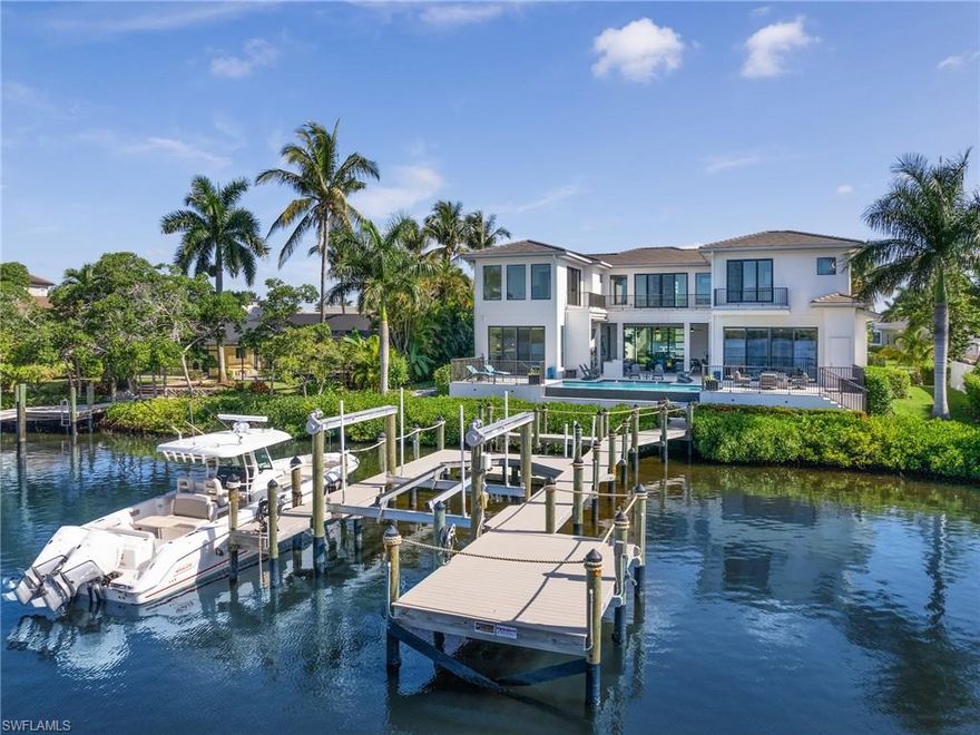This amazing waterfront property truly checks all the boxes. Located in Town and River, one of Southwest Florida's premier locations for leisure and luxury, this stunning waterfront custom built residence built in 2019 boasts breathtaking views and unparalleled boating access to the water. Spanning over 5500 sq ft, the home features 5 bedrooms each with their own en suite bathrooms, a versatile exercise/media room with amazing water views & sundeck, an additional den area or 6th Br and the master suite is on the main floor. An elevator, dual-level laundry facilities, and a generator enhance the convenience. From the moment you enter, you will be captivated by floor-to-ceiling glass and a floating custom staircase, that sets a grand tone. Ideal for entertaining, the main living space includes a chef's kitchen and a 200+ bottle glass-encased wine room. The four-car garage, suitable for lifts, provides ample vehicle storage. Outdoor living is exceptional here with extensive open and covered areas, a fully-equipped grill station featuring a pizza oven, and a sophisticated dock with composite decking, multiple slips, a 16 lb lift, and a floating deck for kayaks and paddleboards. This special residence offers a perfect blend of boating enjoyment and close proximity to all that SWFL has to offer.